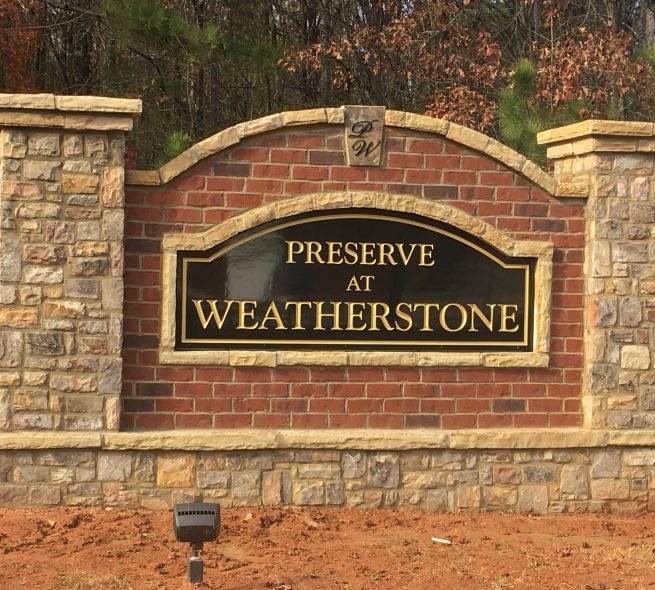 A stone and brick monument sign installed by StoneAge Stonescapes