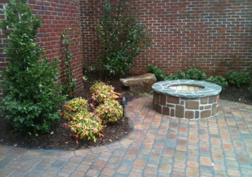 A patio, firepit and stone bench, part of Landscaping in Cumming GA offered by StoneAge Stonescapes