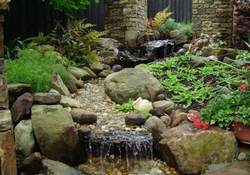 A beautiful waterfall and garden, designed by professional Landscapers in Cumming GA